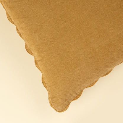 Corduroy Scallop Pillow in Gold styled on a sofa