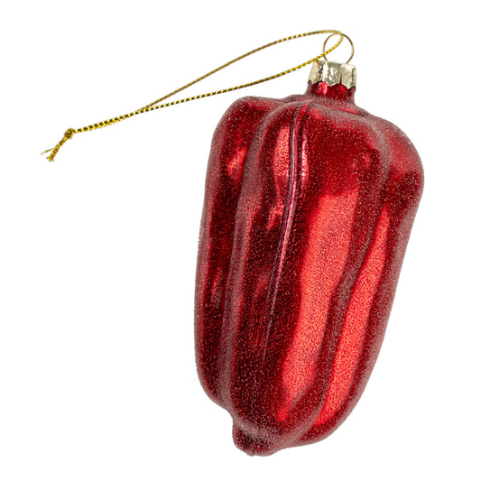 Glossy red glass ornament shaped like a bell pepper with a gold hanging cord