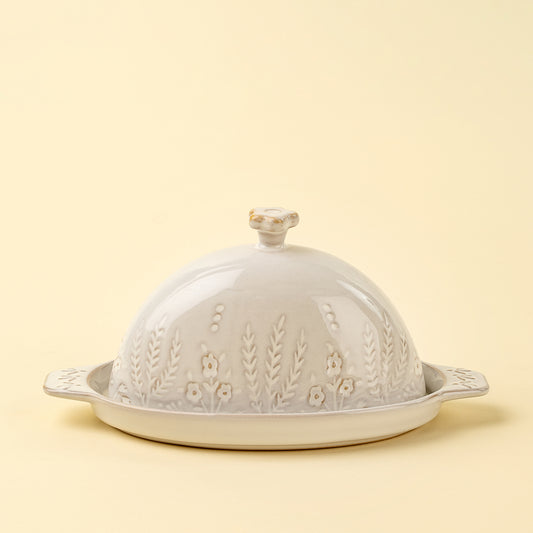 Cream stoneware domed butter dish with a stamped wildflower motif