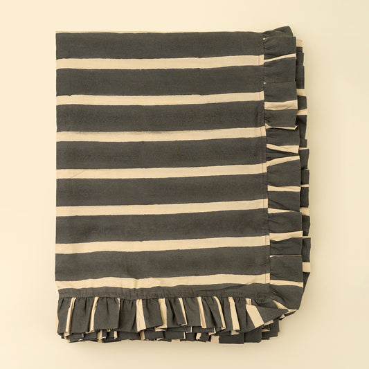 Charcoal and cream block-printed stripe tablecloth with a ruffled edge