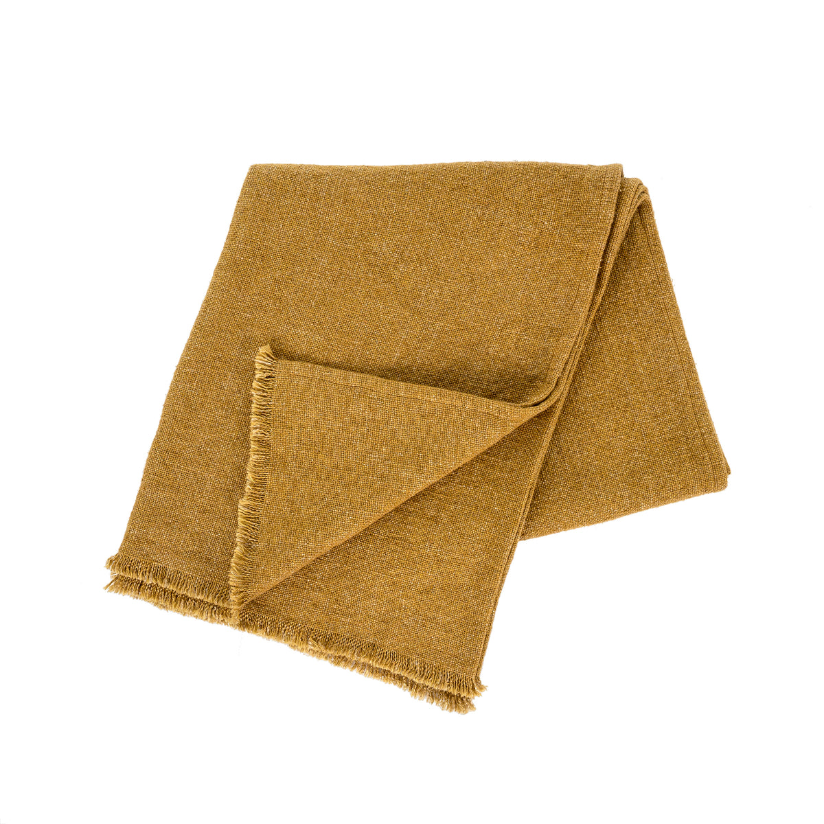 Mustard-gold woven linen blanket with fringed edges, draped over the end of a bed