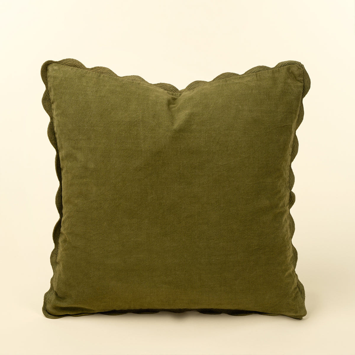Square moss green corduroy pillow with a tone-on-tone scalloped edge