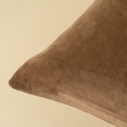 Close-up of the stonewashed velvet texture on the Vera Luxe Velvet Pillow in Caramel