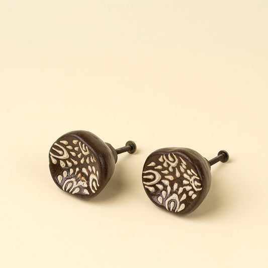 Set of two brown ceramic knobs with a cream floral resist pattern