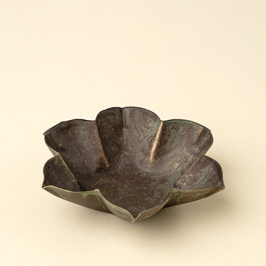 Petal-shaped iron catchall dish with a green patina finish