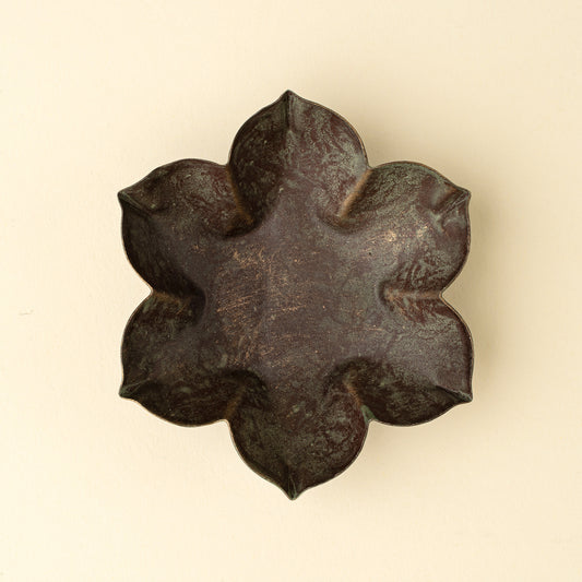 Close-up of the green patina finish on the Florentine Catchall Dish, Petal