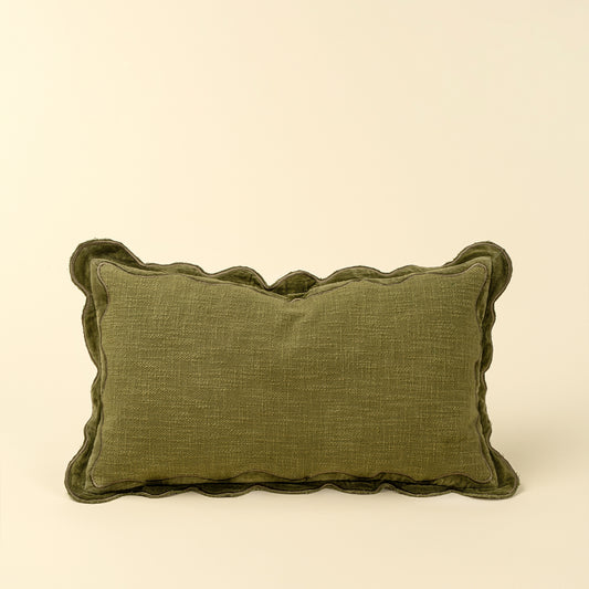 Rectangular moss green pillow with a scalloped velvet border and textured cotton body
