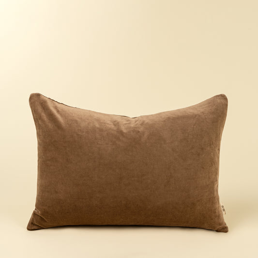 Solid caramel-brown velvet lumbar pillow with a soft stonewashed finish