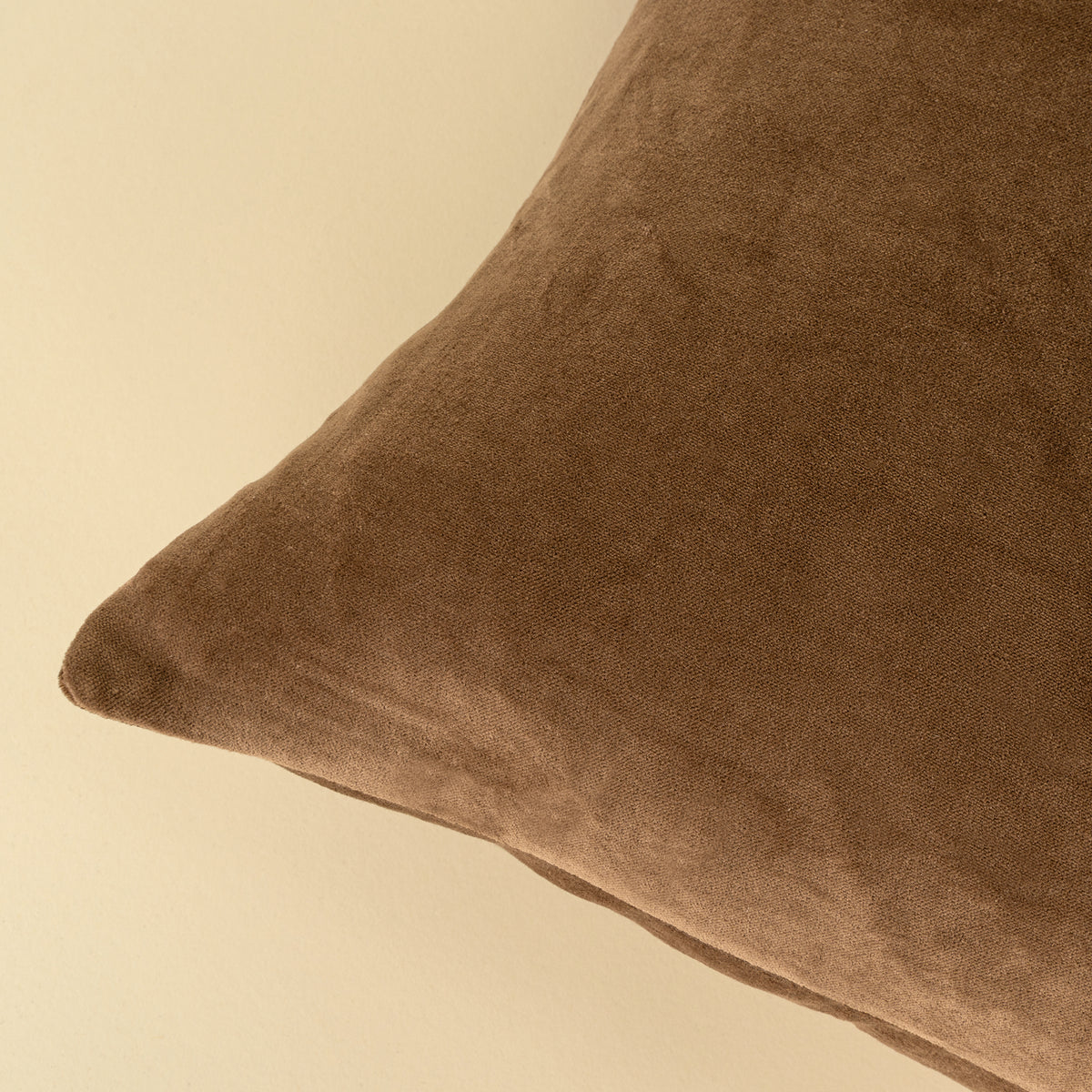 Close-up of the stonewashed velvet texture on the Vera Luxe Velvet Pillow in Caramel