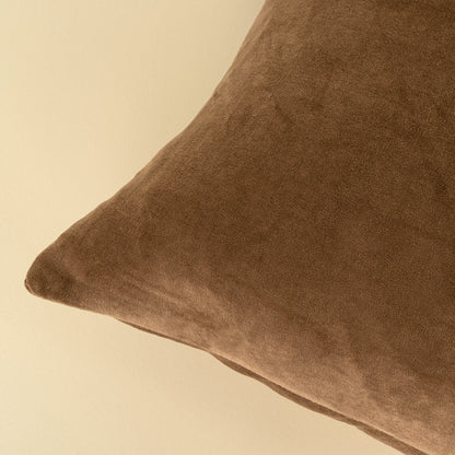 Close-up of the stonewashed velvet texture on the Vera Luxe Velvet Pillow in Caramel