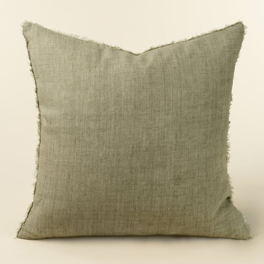 Square sage green linen pillow with a frayed, fringed edge