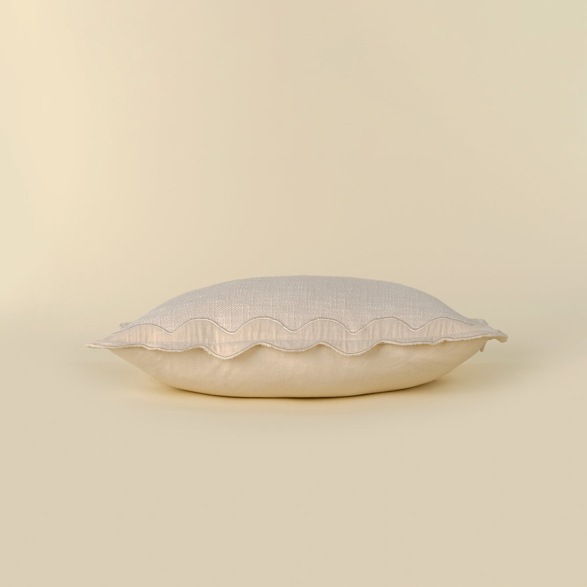 Velvet Scallop Pillow in Ivory styled on a sofa