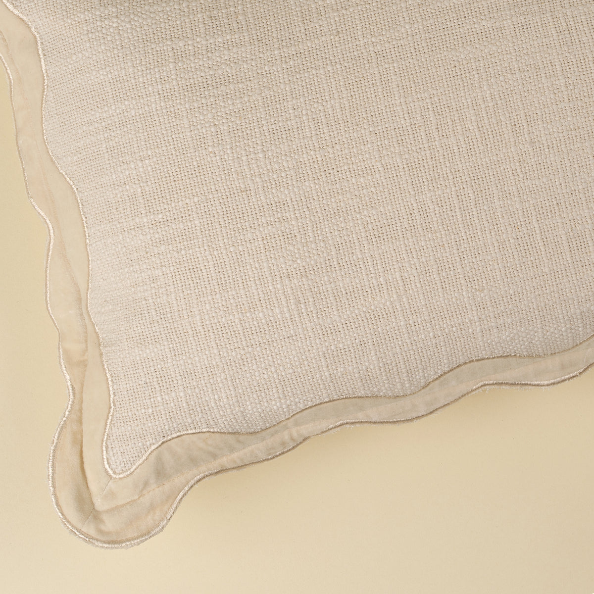 Close-up of the scalloped velvet border on the Velvet Scallop Pillow in Ivory