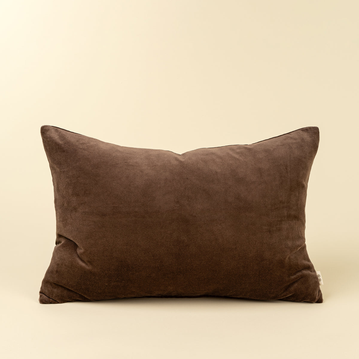 Solid deep brown velvet lumbar pillow with a soft stonewashed finish