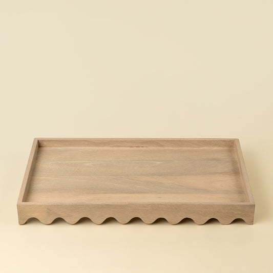 Rectangular light wood tray with a scalloped wave-edge border