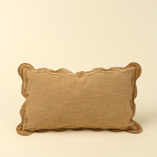 Tan textured pillow with a scalloped gold velvet border