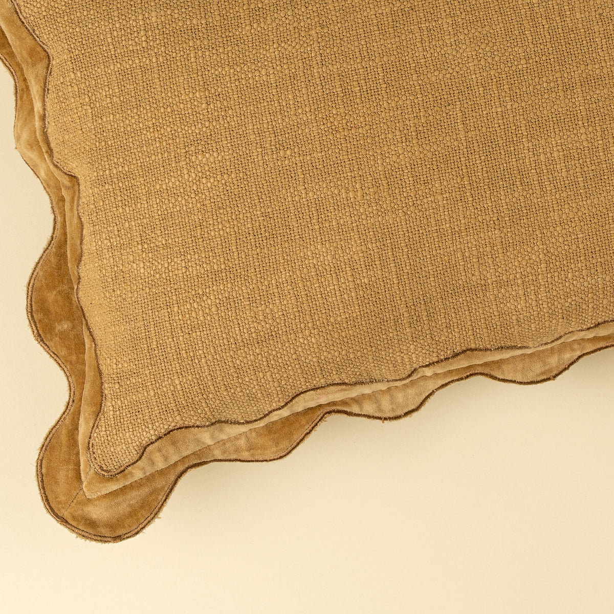 Velvet Scallop Pillow in Gold styled on a bed