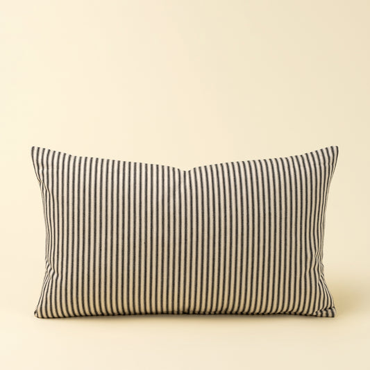 Rectangular cream pillow with black vertical ticking stripes