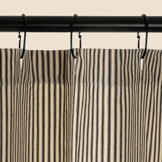 Black Ticking Shower Curtain shown hanging in a full bathroom scene