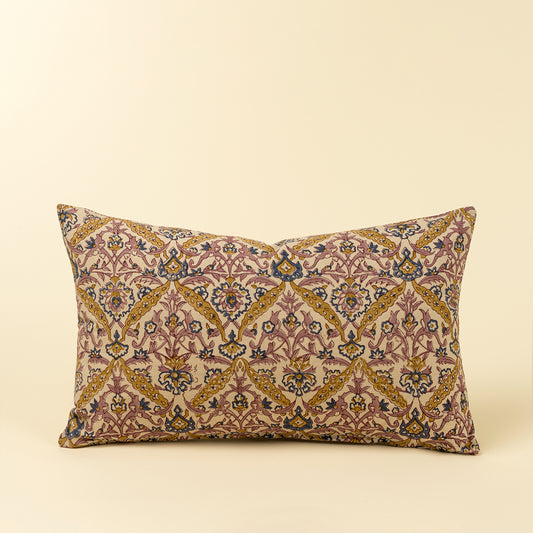 Rectangular lumbar pillow with a hand block printed floral vine pattern in pink, blue, and mustard on cream linen