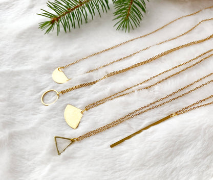 Model wearing raw brass circle pendant necklace
