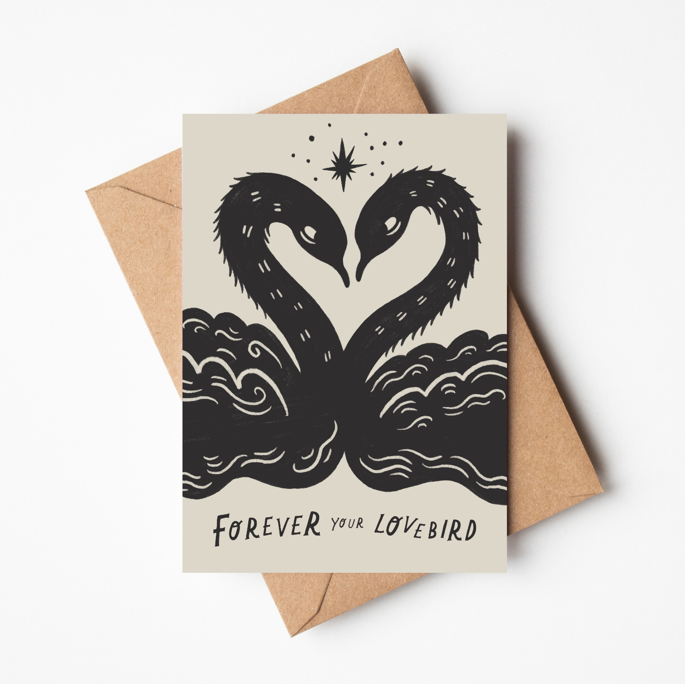 'Lovebirds' romantic card featuring two black illustrated swans forming a heart shape beneath a star, with 'Forever Your Lovebird' text, on a cream background