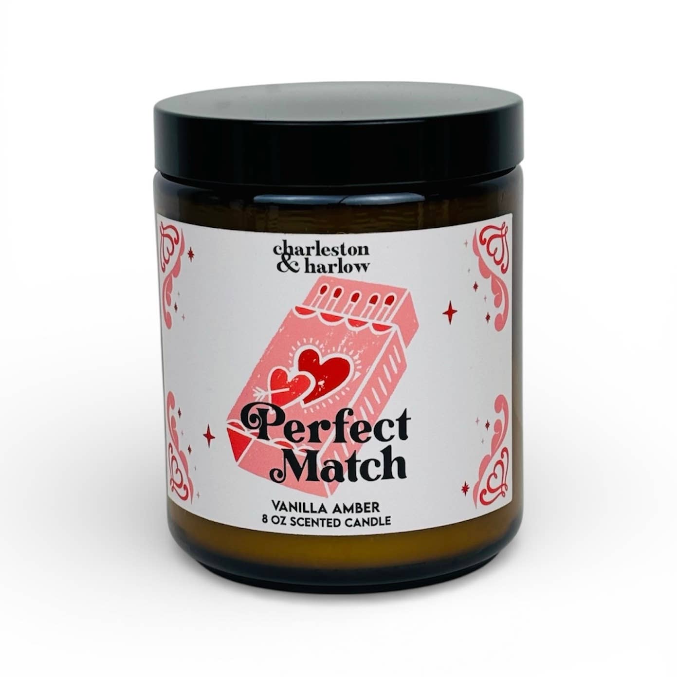 Charleston & Harlow Perfect Match soy candle in amber glass jar with cream label featuring an illustrated matchbook and heart