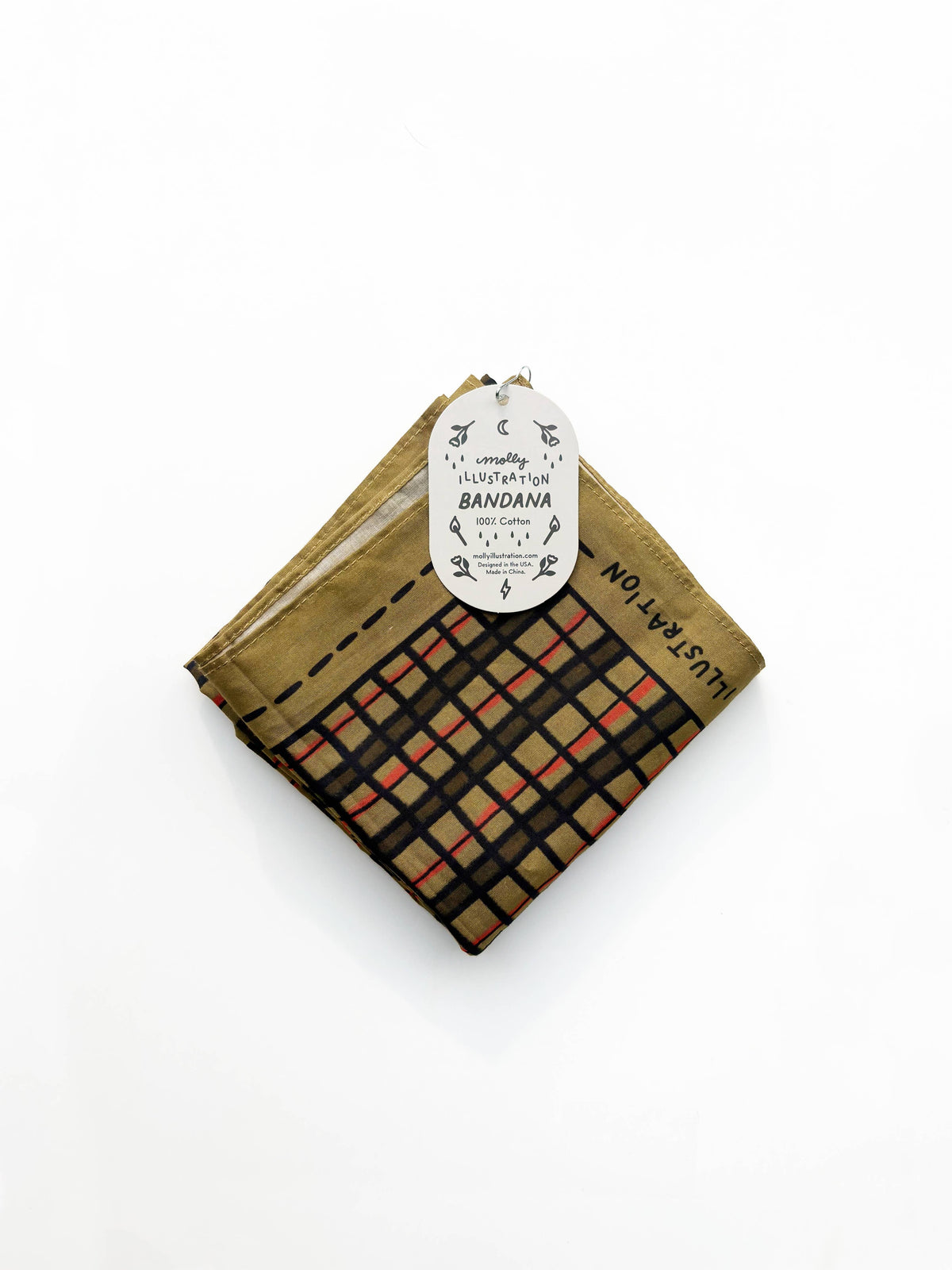 Folded bandana in a gold and brown wonky plaid print with a Molly Illustration branded packaging tag