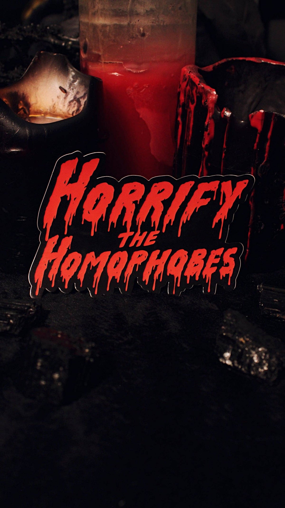 Horrify The Homophobes sticker applied to a laptop lid for scale