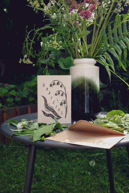 Close-up detail of the lily of the valley illustration on the 'Grateful' gratitude card