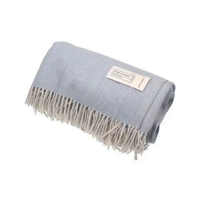 Rolled Cornflower herringbone wool throw blanket in sky blue with grey fringe and House of Juniper label - PABOOM