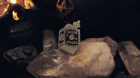 Close-up of the enamel detailing on the Queer Magic spellbook pin