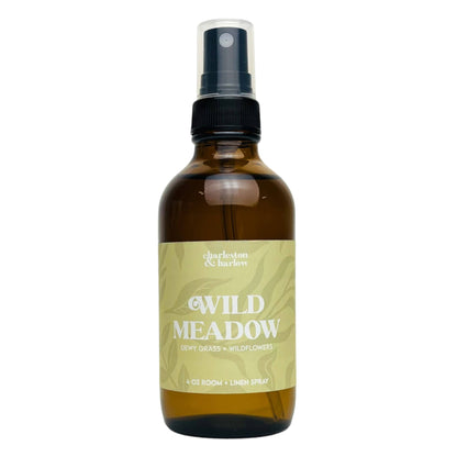 Amber glass spray bottle of Charleston & Harlow Wild Meadow room and linen spray with sage green leaf-patterned label