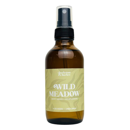 Amber glass spray bottle of Charleston & Harlow Wild Meadow room and linen spray with sage green leaf-patterned label