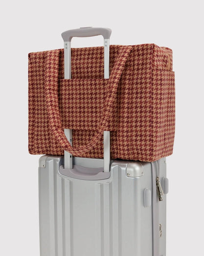 BAGGU Small Cloud Carry-On in tan houndstooth shown flat to highlight its exterior pockets
