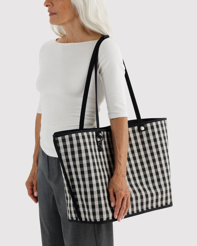 Close-up detail of the BAGGU Large Nylon Reversible Tote's snap closures and charm loops