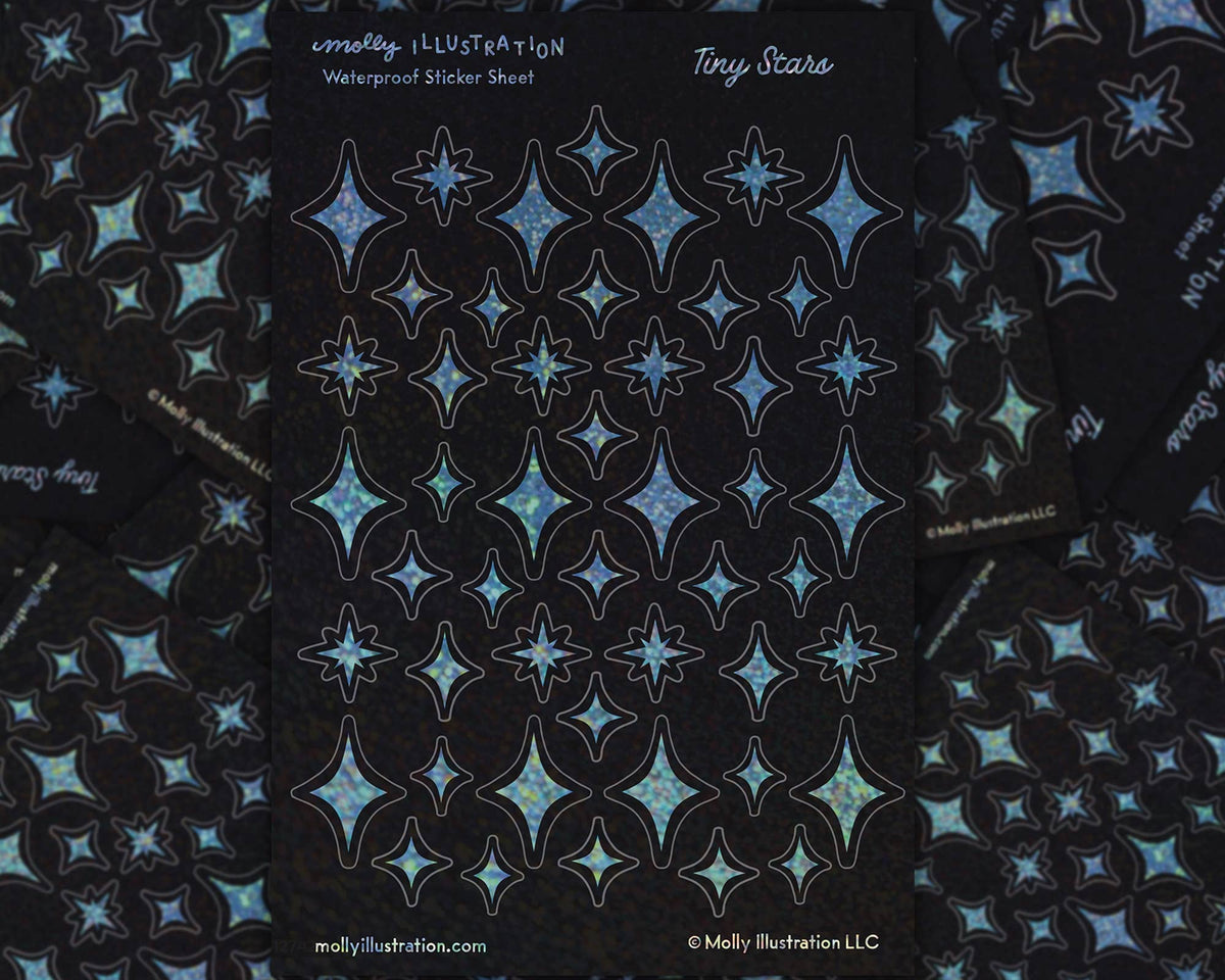A 4x6 inch sticker sheet covered in tiny glittery rainbow star stickers against a dark background
