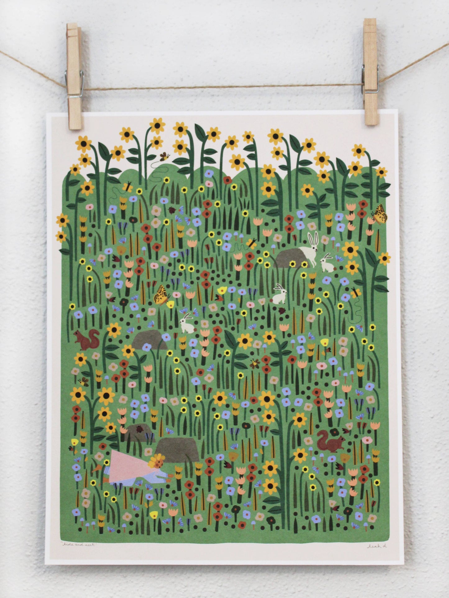 Dense green wildflower meadow archival print with rabbits, a squirrel, and sunflowers, clipped to a string — PABOOM