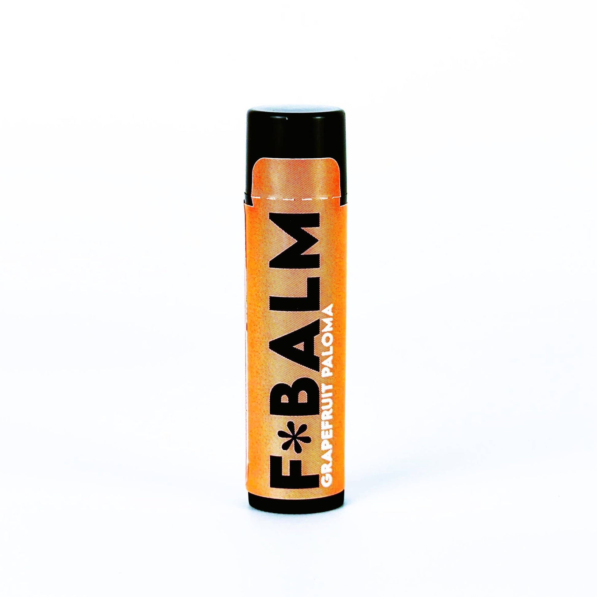 Charleston & Harlow F*Balm Grapefruit Paloma lip balm tube with orange kraft-paper label