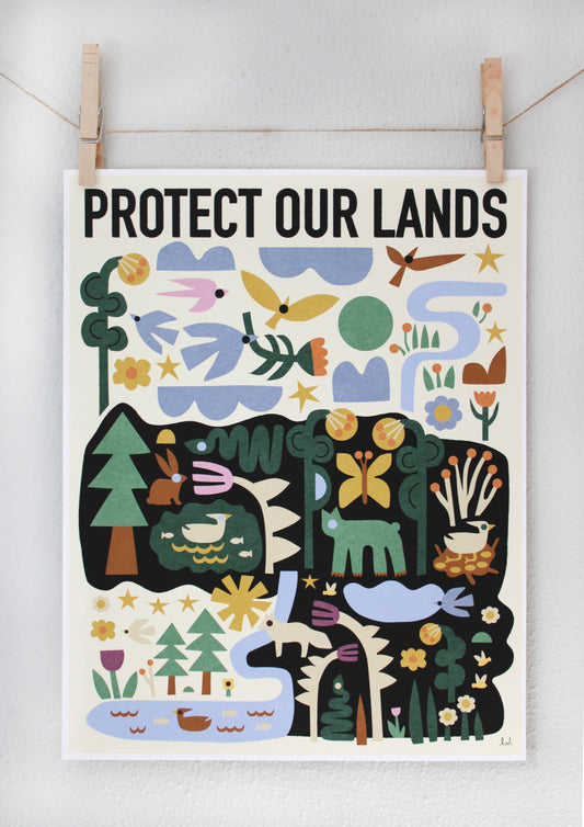 Protect Our Lands archival print with a folk-art forest and river scene featuring deer, rabbits, and birds, clipped to a string — PABOOM