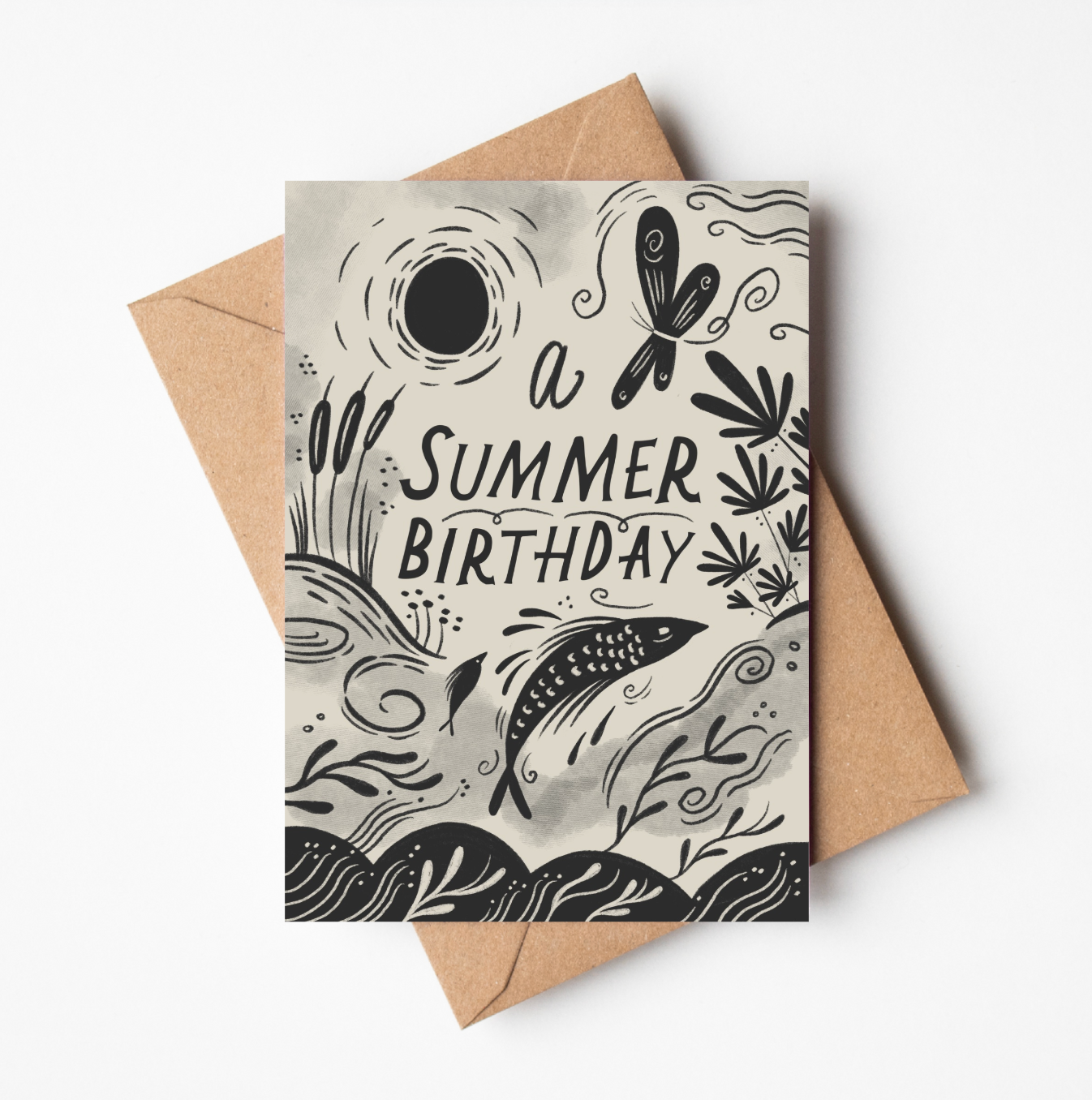 'A Summer Birthday' card featuring illustrated dragonflies, bulrushes, and a leaping fish beneath a sun, with hand-lettered 'A Summer Birthday' text