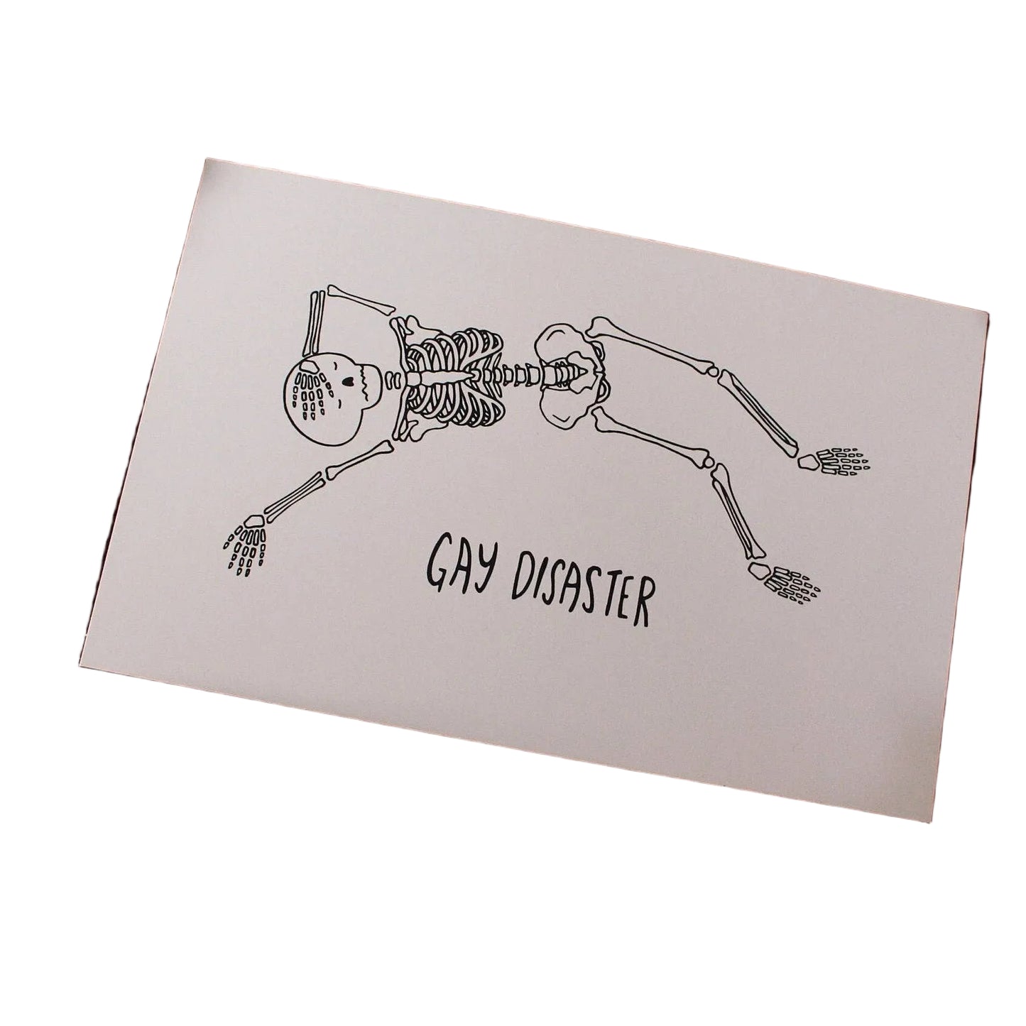 Hand-drawn illustrated print of two skeletons kissing head to head with the hand-lettered words Gay Disaster below, on cream cardstock