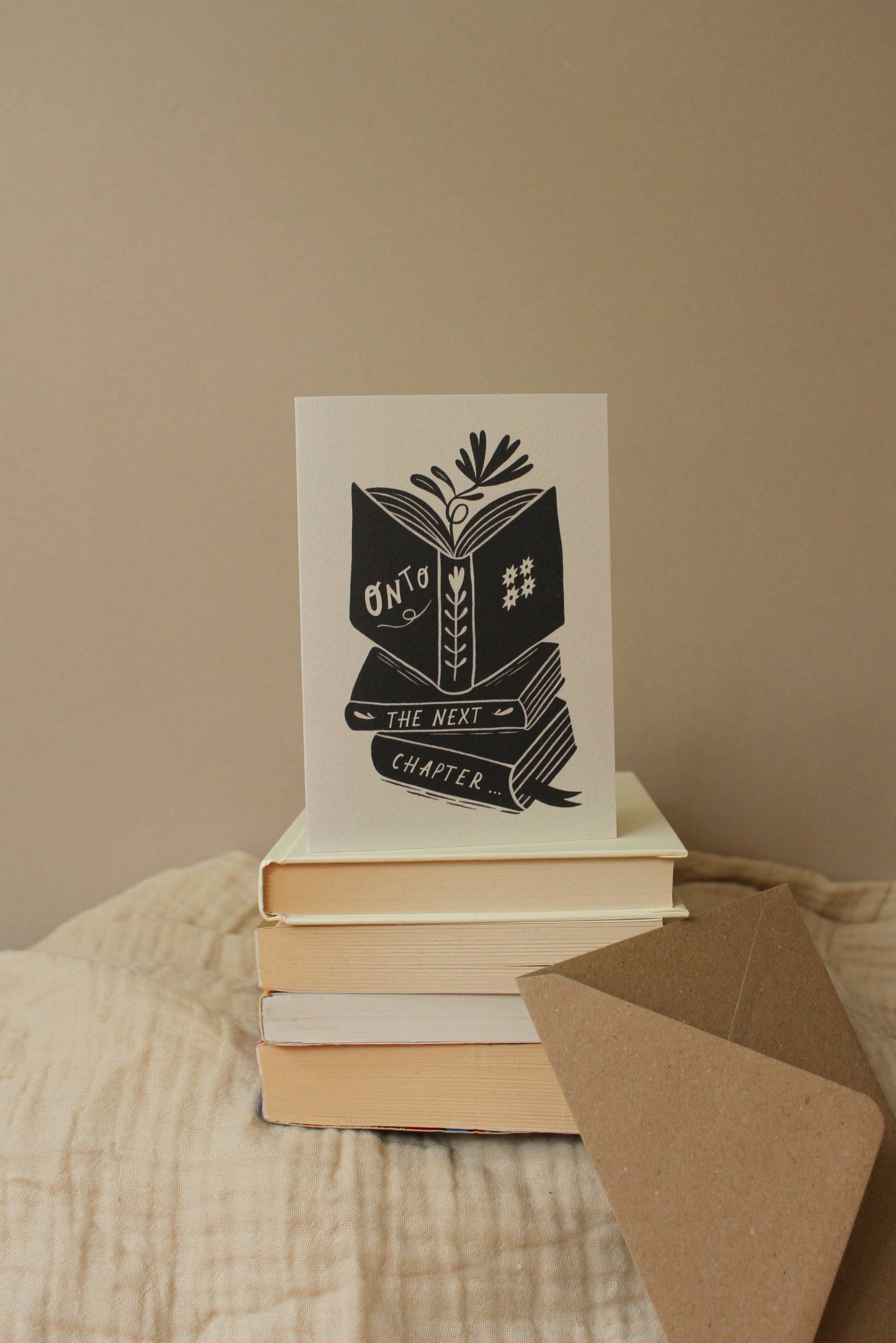 'Onto The Next Chapter...' thoughtful card shown at an angle with envelope