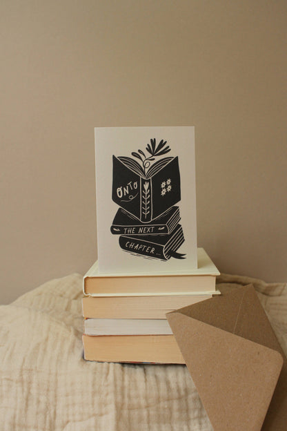 'Onto The Next Chapter...' thoughtful card shown at an angle with envelope
