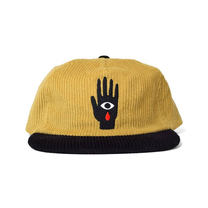 Black and mustard gold corduroy dad hat with an embroidered black hand patch featuring a white eye and red teardrop - PABOOM