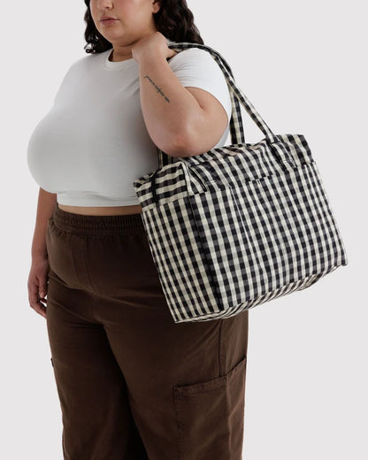 Interior view of the BAGGU Small Cloud Carry-On in black and cream gingham showing the detachable storage pouch