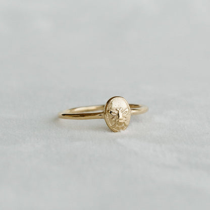 Bee Signet Ring with an embossed bee motif on an oval gold face - PABOOM