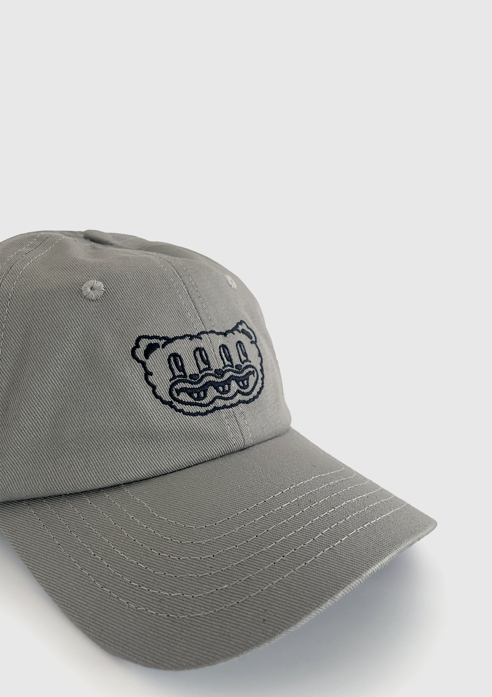 Side view of grey embroidered dad hat showing adjustable metal clasp - PABOOM
