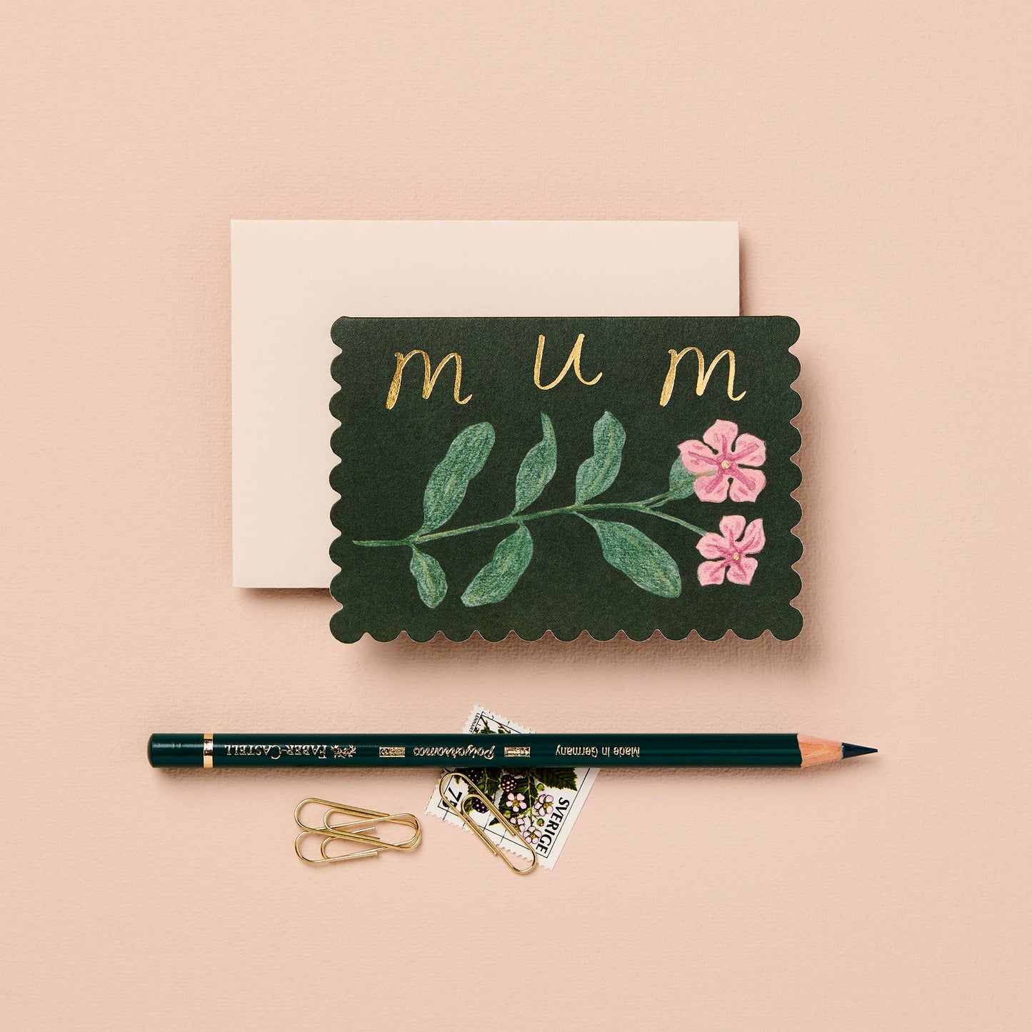 Deep green mini card with a pink wildflower illustration, reading mum in gold script