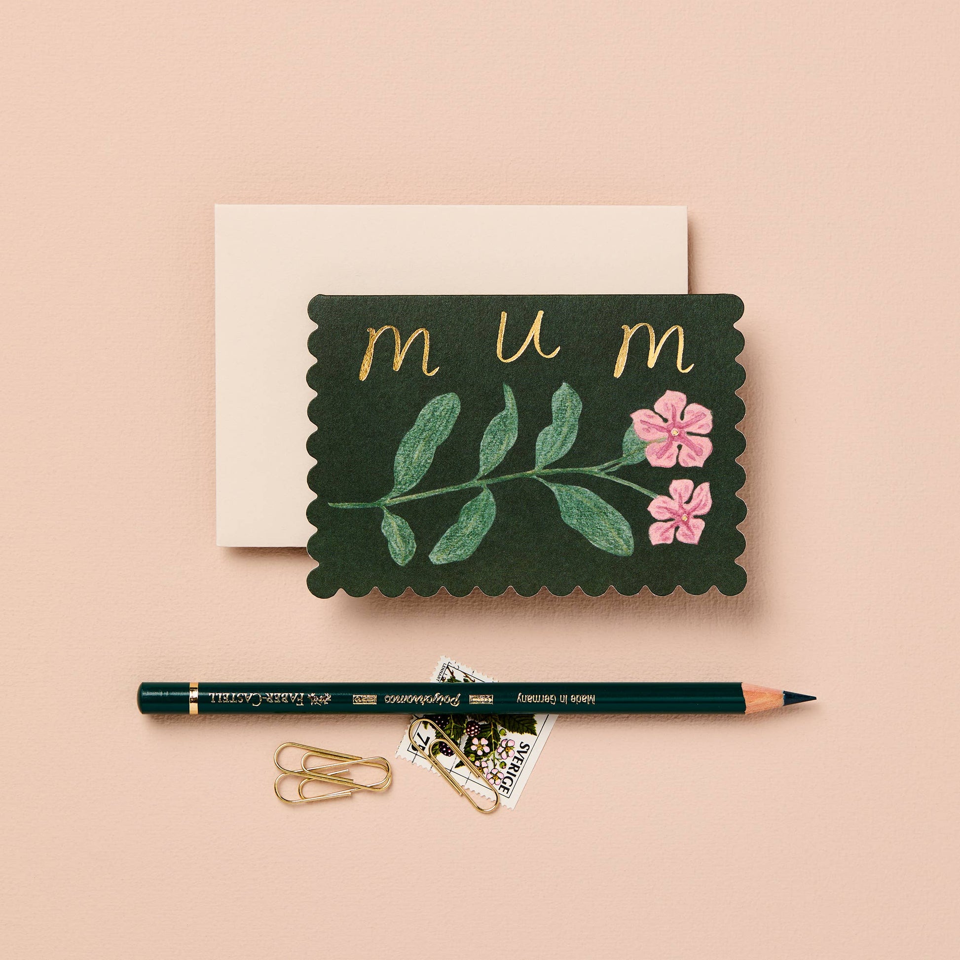Deep green mini card with a pink wildflower illustration, reading mum in gold script